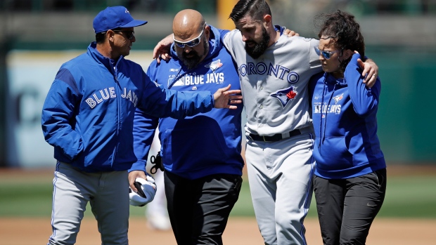 Blue Jays' Shoemaker helped off after injury during rundown