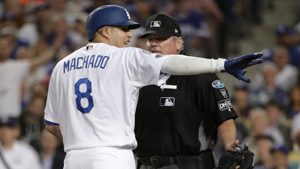 MLB fines Dodgers' Machado for running into Brewers' Aguilar