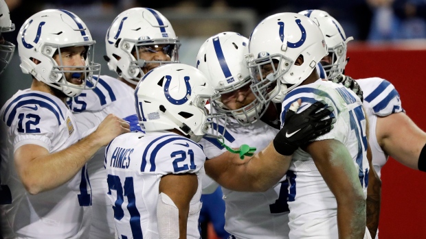 Detroit Lions offense huddles against Indianapolis Colts during an