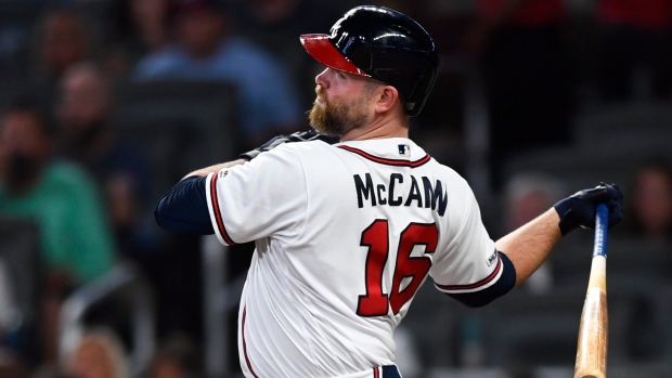 Braves catcher Brian McCann enjoys family time with his 1-year old