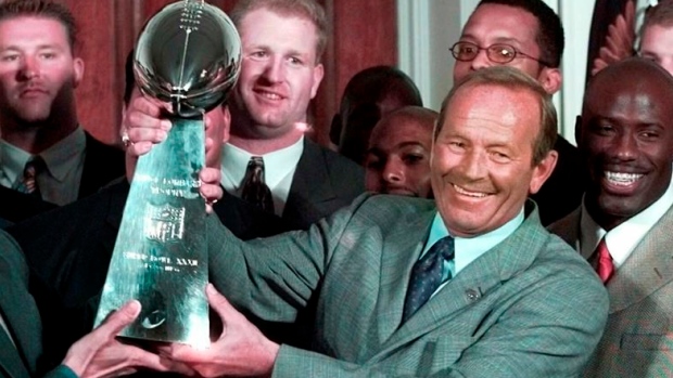 Shannon Sharpe of the Denver Broncos holds the Lombardi Trophy