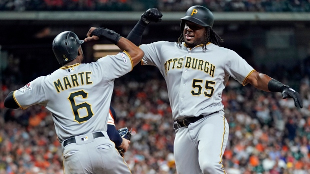 Pittsburgh Pirates' Starling Marte, right, celebrates with Cole