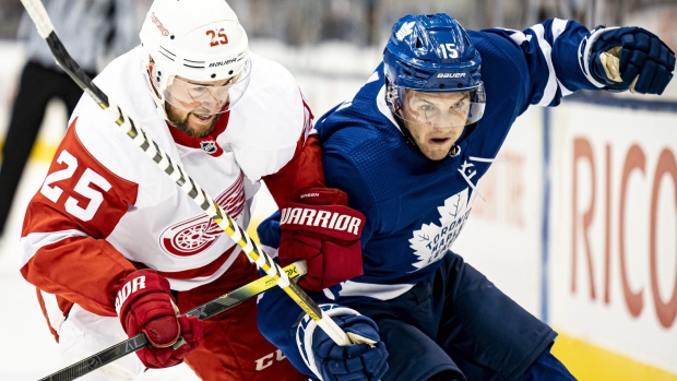 Leafs centre Alexander Kerfoot battles Red Wings defenceman Mike Green.