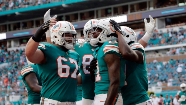 Bag of tricks helps Dolphins rally past Eagles