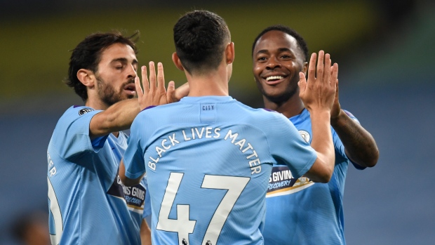 Manchester City's Phil Foden celebrates with Raheem Sterling