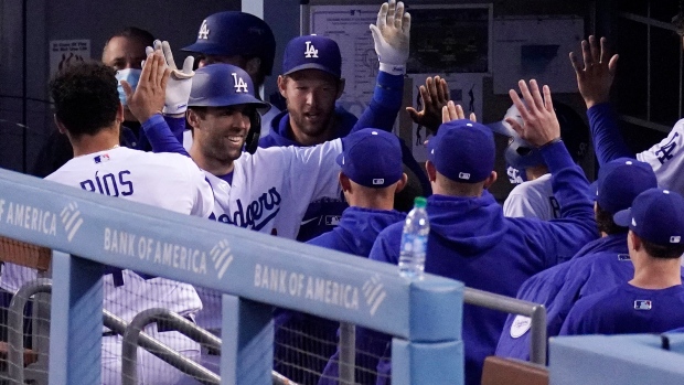 Betts, Bauer star for new fans as Dodgers crush Rockies 7-0