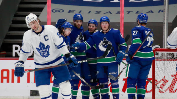 Canucks celebrate behind John Tavares