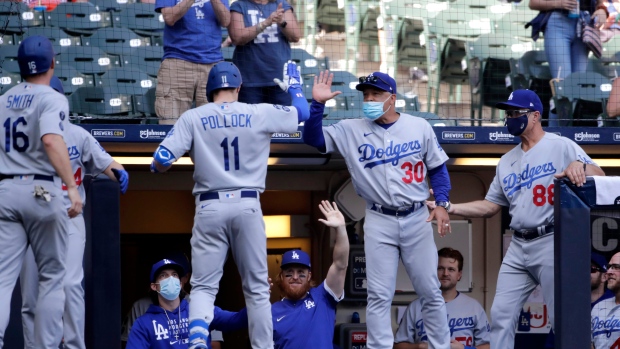 Los Angeles Dodgers' AJ Pollock is hit by a pitch from San