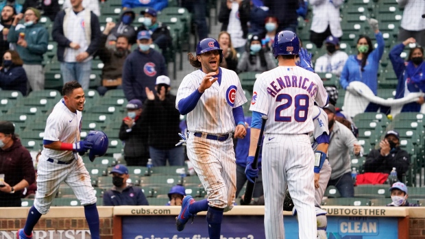 Hendricks has 2-run 2B, pitches into 9th; Cubs top Reds 3-1