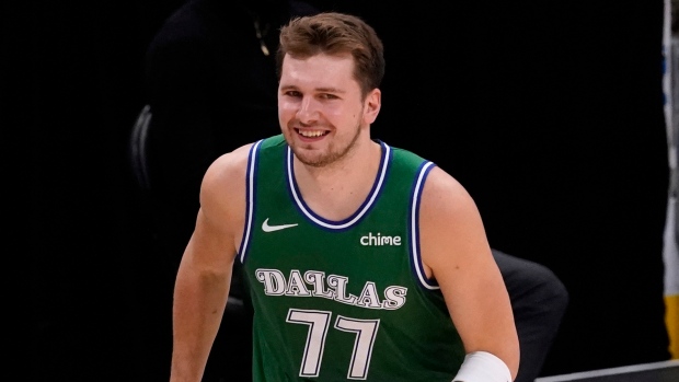 Dallas Mavericks forward Luka Doncic (77) pulls his jersey over his face  after missing a shot late in the second half of the team's NBA basketball  game against the Oklahoma City Thunder
