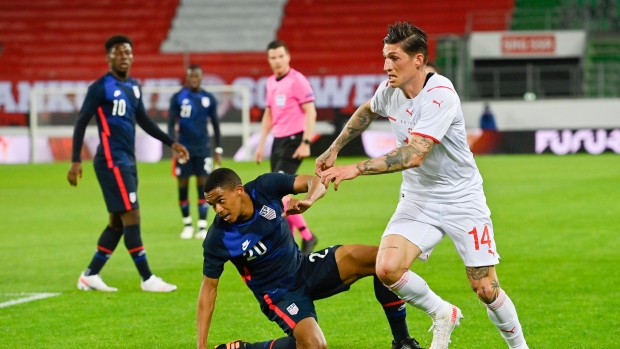 USA's Reggie Cannon, left, and Switzerland's Steven Zuber