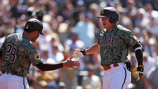 Ha-Seong Kim of the San Diego Padres is congratulated by Fernando
