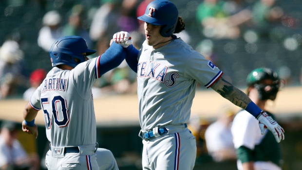 Rangers score five in 8th, come back to nip A's 8-6