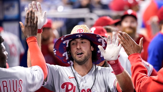 Philadelphia Phillies star Bryce Harper trades hats with a fan