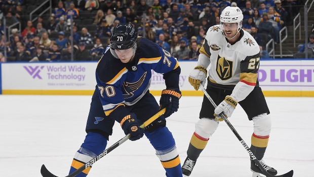 St. Louis Blues' Justin Faulk (72) checks Vegas Golden Knights' Chandler  Stephenson into the bo …