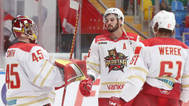 Kunlun Red Star goaltender Jeremy Smith, Ryan Sproul and Ethan Werek