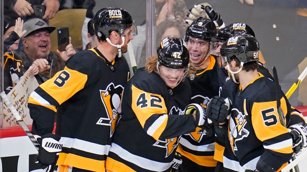 Pittsburgh Penguins' Kasperi Kapanen (42) celebrates his third goal of the team's  NHL hockey game against the Minnesota Wild, during the third period in  Pittsburgh, Saturday, Nov. 6, 2021. The Wild won