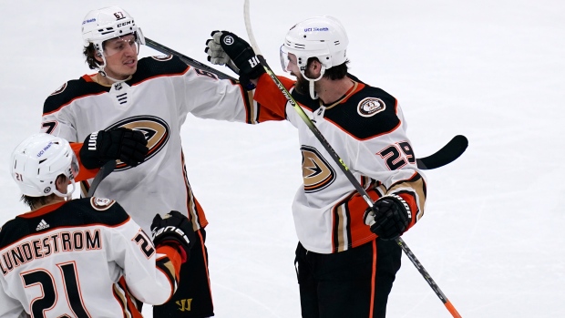 Anaheim Ducks forward Troy Terry, right, celebrates his goal with teammates  Ryan Getzlaf, left, and Sonny Milano during the third period of an NHL  hockey game against the Montreal Canadiens, Sunday, Oct.