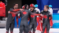 Charles Hamelin celebrates with teammates after gold medal win 