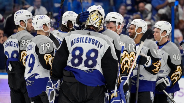 Tampa Bay Lightning's Nikita Kucherov (86) and goalie Andrei Vasilevskiy  (88) hoist the Stanley …