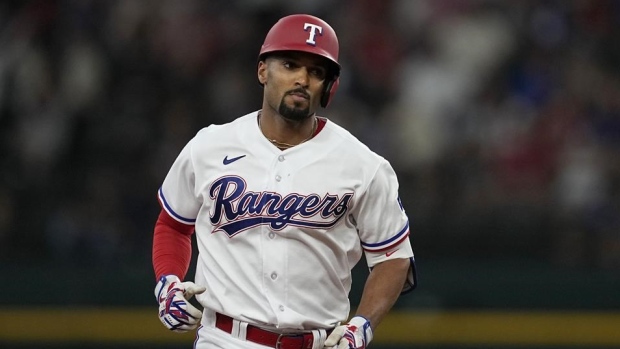 Marcus Semien of the Texas Rangers rounds the bases after hitting a