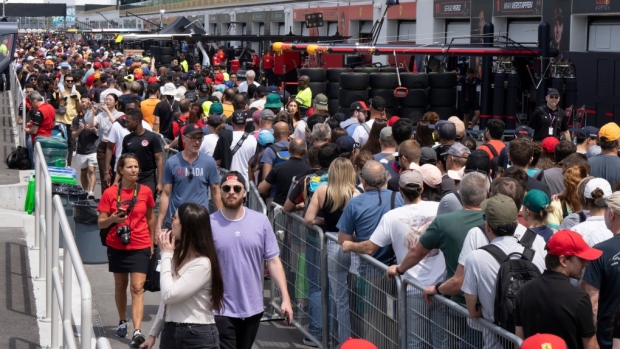 Race fans walk through pit lane during the open house at the Canadian Grand Prix.