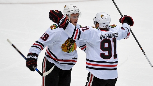 Chicago Blackhawks player Jonathan Toews raises the Stanley Cup