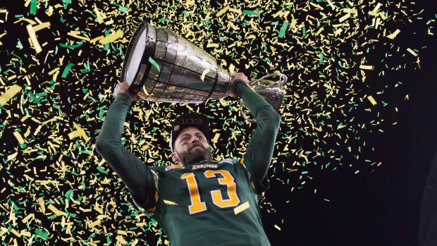 Mike Reilly hoists the Grey Cup