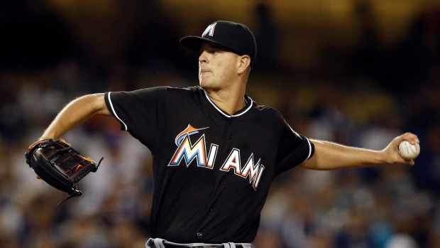 Miami Marlins pitcher Mike Dunn holds a Jose Fernandez jersey during