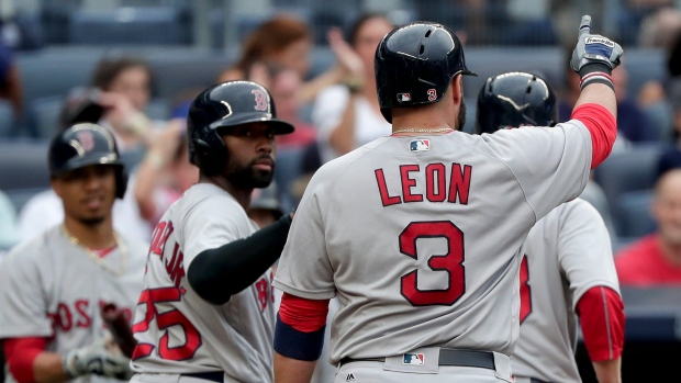 Boston Red Sox catcher CHRISTIAN VAZQUEZ talks with relief pitcher JUNICHI  TAZAWA