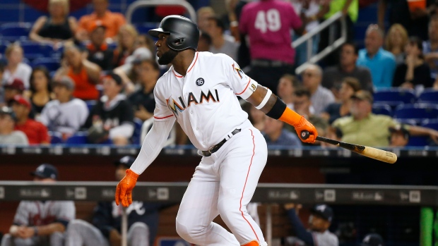 Cat takes cover as Ozuna's 2 HRs help Miami beat Braves, 8-4