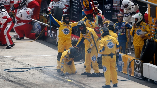 Kyle Busch crew members react after he leaves pit with loose wheel