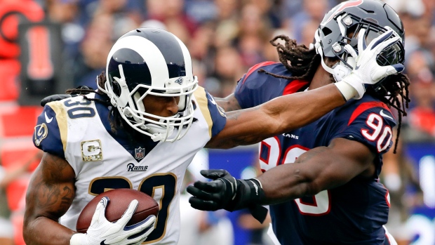 Los Angeles Rams' Todd Gurley II (left) is tackled by Cincinnati