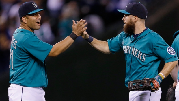 Seattle Mariners' Dustin Ackley connects with a pitch for a double